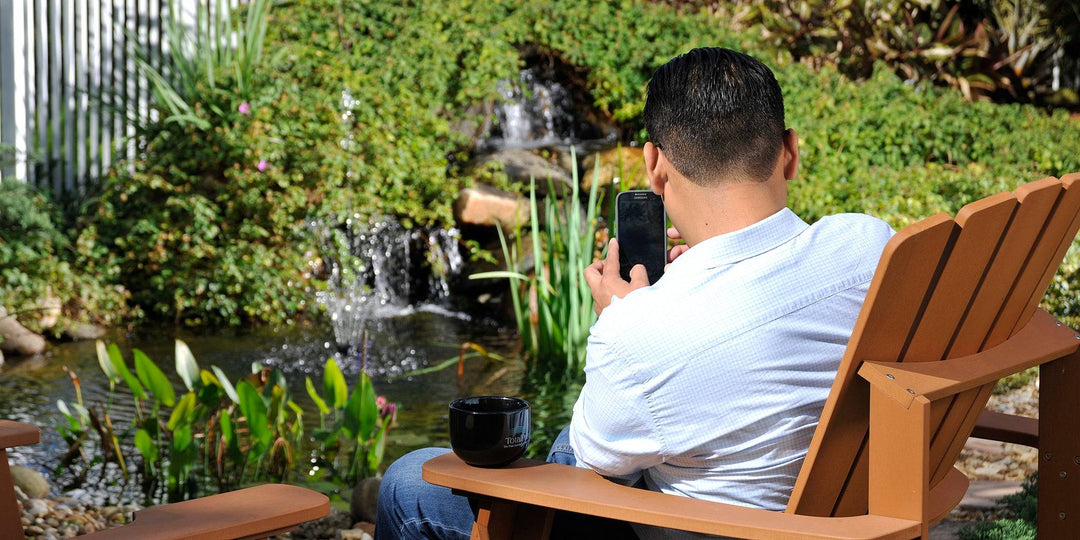 man taking a picture of his pond