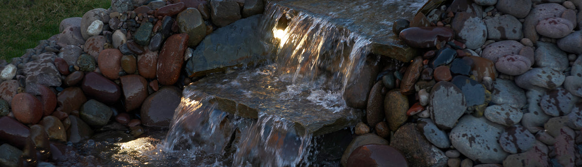 Beautiful backyard waterfall built with TotalPond supplies